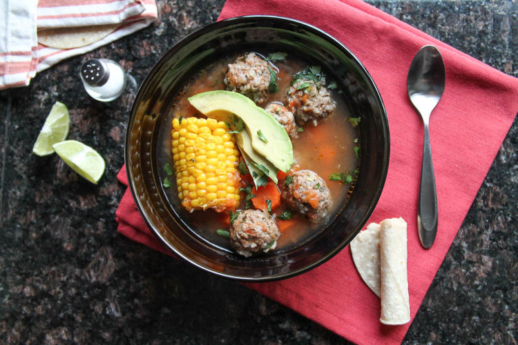 A Mexican meatball and vegetable soup in a tomato broth