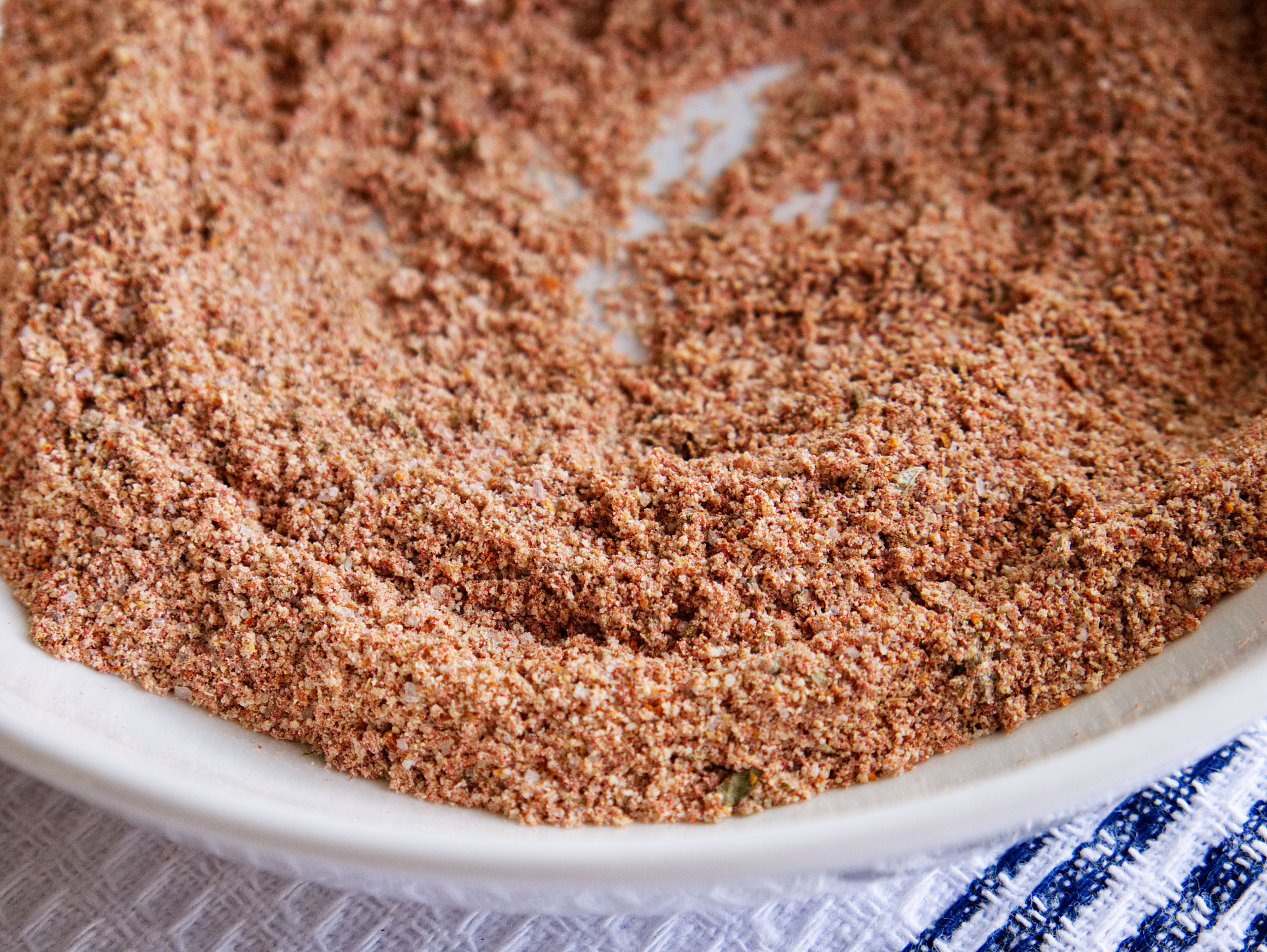 A close-up photo of taco seasoning in a white bowl.